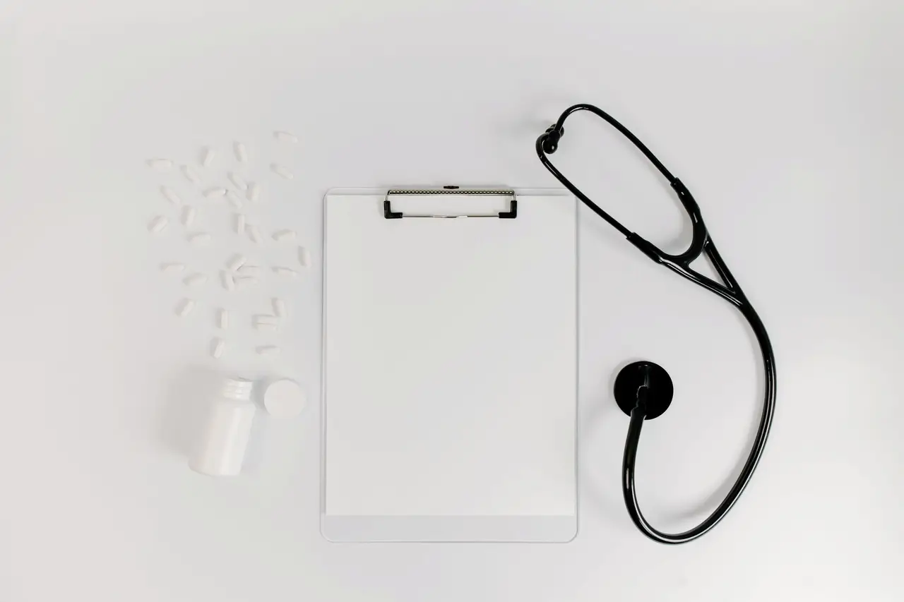White Paper on Clipboard beside Black Stethoscope